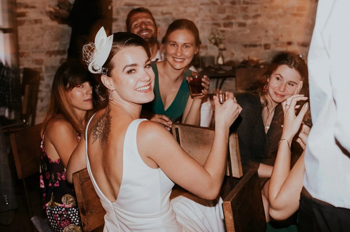 Uśmiechnięta kobieta na przyjęciu w eleganckiej sukni.