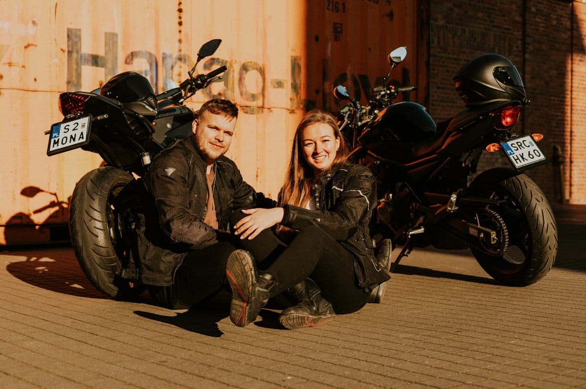 Para siedząca przy motocyklach na tle kontenera